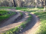 Aggressive mountain biking has created 3 banked curves on the trail.
