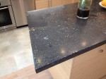 Concrete counter top with rocks and glass tiles incorporated.