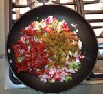 Veggie filling with sun dried tomatoes and golden raisins in the wok.