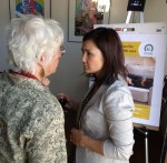 Lead Community Organizer Bonnie London, RN, speaks with a volunteer at the Coffee Garden Obamacare launch.