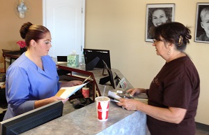 Roxanne discuss health plans with a dental hygienist.