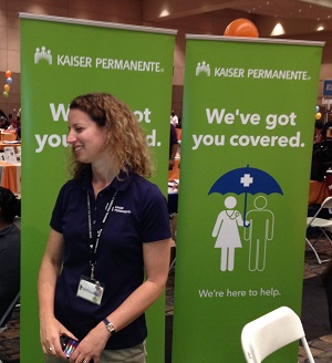 Kaiser representative explains the health plans to a We Connect attendee in Sacramento.