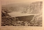 Brush Dam, North Bloomfield Company, For impounding tailings. Dam is in the washed-out ground. It is sixty-five feet high and is raised as the tailings accumulate. The impounded tailings may be seen in the artotype. Nevada City c. 1890
