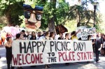 Students march against excessive police presence for 100th Picnic Day celebration.
