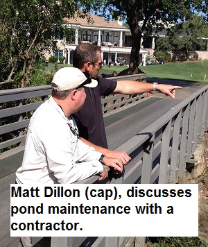 Matt Dillon discuss weed control in the Linda Creek pond with a contractor.