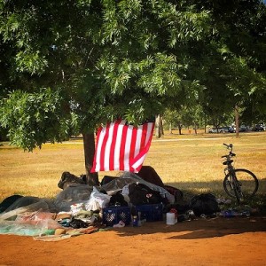 Homeless camper flies an American flag from their campsite in Placer County.
