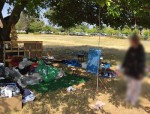Homeless woman deconstructs her campsite to comply with Placer County code of no roofs.