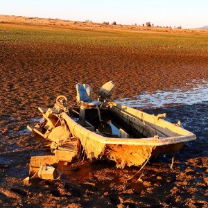 Sunken bass boat exposed by low Folsom Lake drought levels.