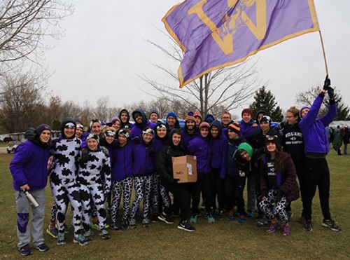 Walker lifts the Williams College flag at the cross country race in Oshkosh Wisconsin. It was a memorable and long road trip from Massachusetts. 