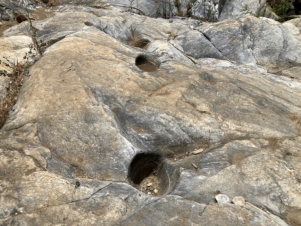Native American bed rock mortars in the rock above Coyote Creek and Natural Bridges tunnel.