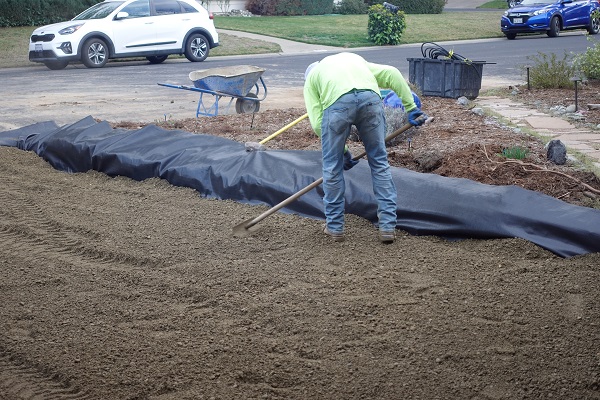 Geotextile fabric laid down before road based is added on top.