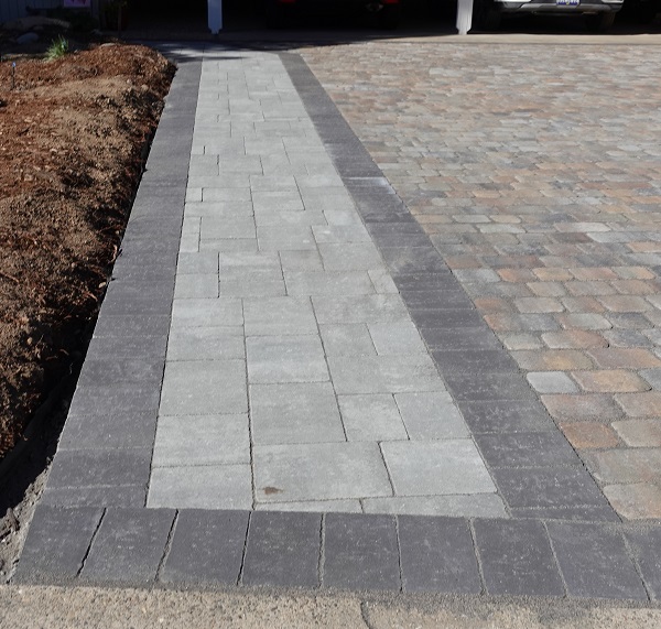 Antiqued Flat Top Calstone pavers used for the walkway up to carport. Silverstone color interior and charcoal color perimeter.