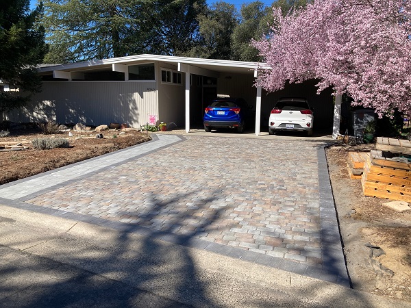 Finished concrete paver driveway with Calstone Belgian Stone pavers in Sequoia Sandstone color and Antiqued Flat Top pavers for walkway.