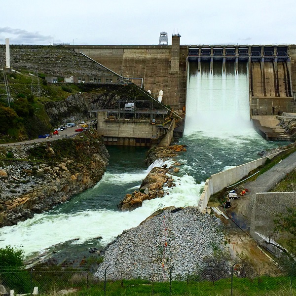 Folsom Dam releasing water through the 5 main gates of the dam.