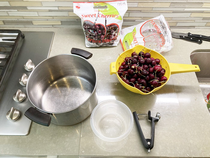 I start with 2 bags of fresh cherries, the hand pitter, and an 8-quart stock pot.