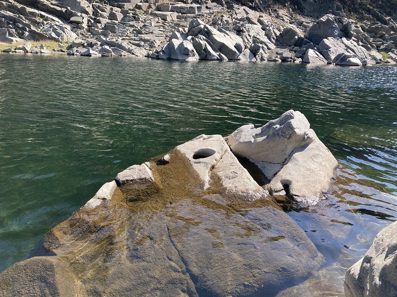 The hole at the tip of the partially submerged rock looks to be a Native American hole that may have been used for cooking next to the North Fork of the American River.